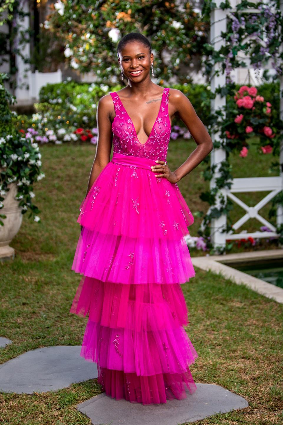 Vakoo Kauapirura stands in a pink dress at the beginning of The Bachelor Australia 2019