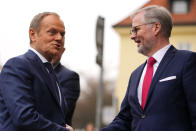 Czech Republic's Prime Minister Petr Fiala, right, welcomes Poland's Prime Minister Donald Tusk at the V4 meeting in Prague, Czech Republic, Tuesday, Feb. 27, 2024. (AP Photo/Petr David Josek)