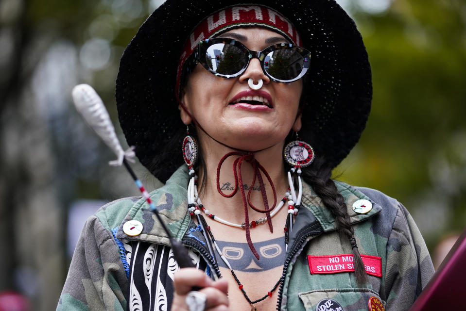 Aimee Phair of the Lummi Nation drums during a celebratory march for Indigenous Peoples Day, Monday, Oct. 9, 2023, in Seattle. (AP Photo/Lindsey Wasson)