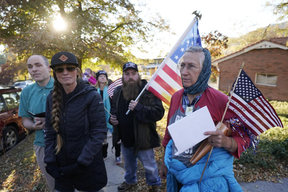 Anti-mask protestors march to the home of Utah Epidemiologist Dr. Angela Dunn Thursday, Oct. 29, 2020, in Salt Lake City. About a dozen protestors stood across from Dunn's home Thursday morning and evening. Utahns opposed to the Utah Department of Health's mask requirements are turning their scorn from Utah Gov. Gary Herbert to a new target this week state epidemiologist Dr. Angela Dunn. (AP Photo/Rick Bowmer)