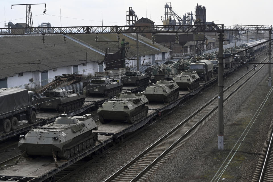 Russian armored vehicles are loaded onto railway platforms at a railway station in region not far from Russia-Ukraine border, in the Rostov-on-Don region, Russia, Wednesday, Feb. 23, 2022. U.S. President Joe Biden announced the U.S. was ordering heavy financial sanctions against Russia, declaring that Moscow had flagrantly violated international law in what he called the "beginning of a Russian invasion of Ukraine." (AP Photo)