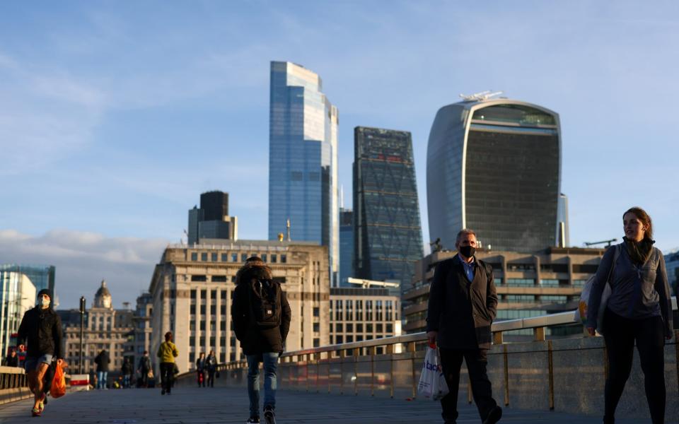 Commuters cross London Bridge in October 2020 - but a third lockdown means most workers will not return to offices for some time yet - Simon Dawson /Bloomberg
