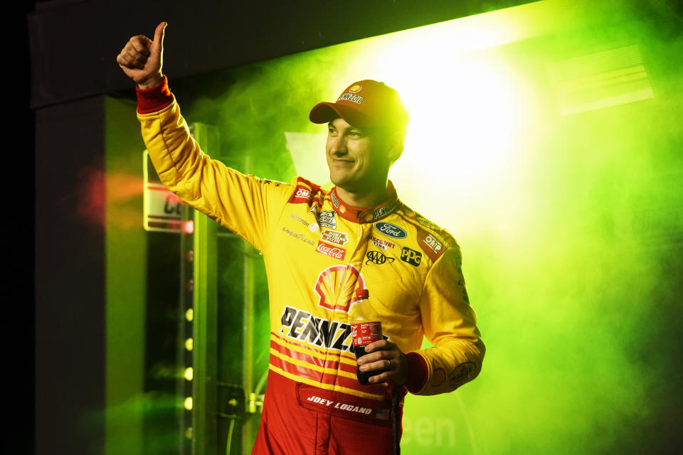 Joey Logano waves to fans during driver introductions before two Daytona 500 qualifying auto races at Daytona International Speedway, Thursday, Feb. 15, 2024, in Daytona Beach, Fla. (AP Photo/John Raoux)