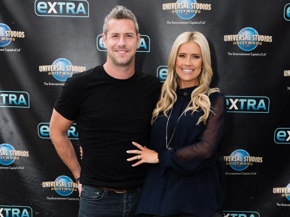 Ant Anstead and Christina Haack pose on a red carpet.