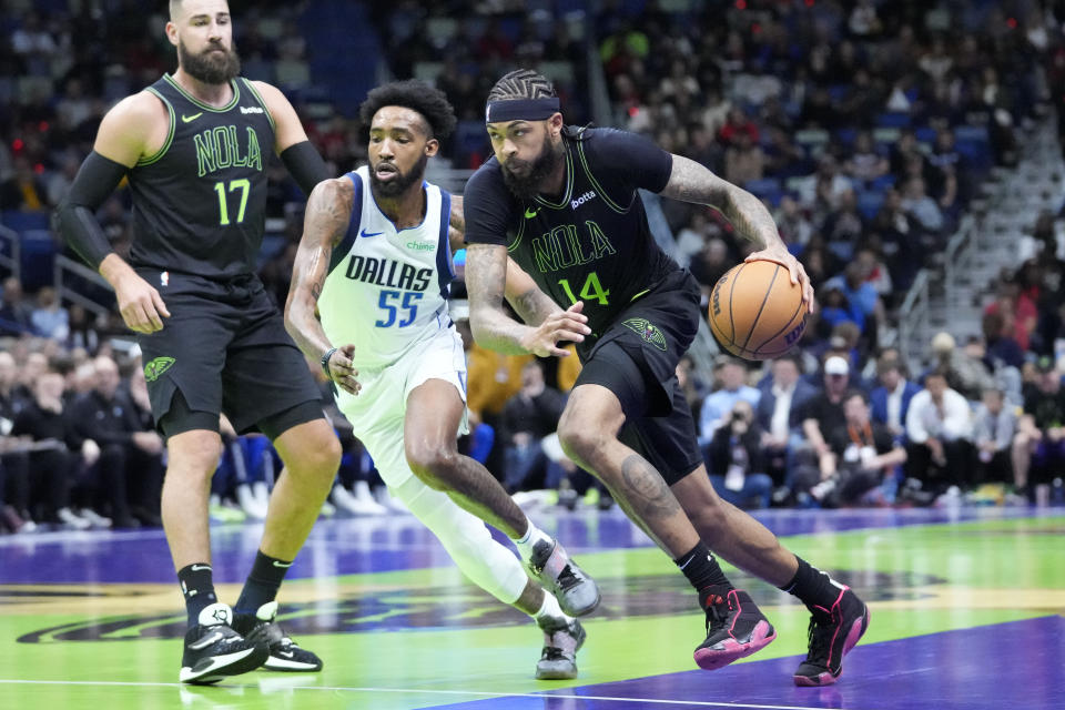 New Orleans Pelicans forward Brandon Ingram (14) drives to the basket against Dallas Mavericks forward Derrick Jones Jr. (55) in the first half of an NBA basketball game in New Orleans, Tuesday, Nov. 14, 2023. (AP Photo/Gerald Herbert)