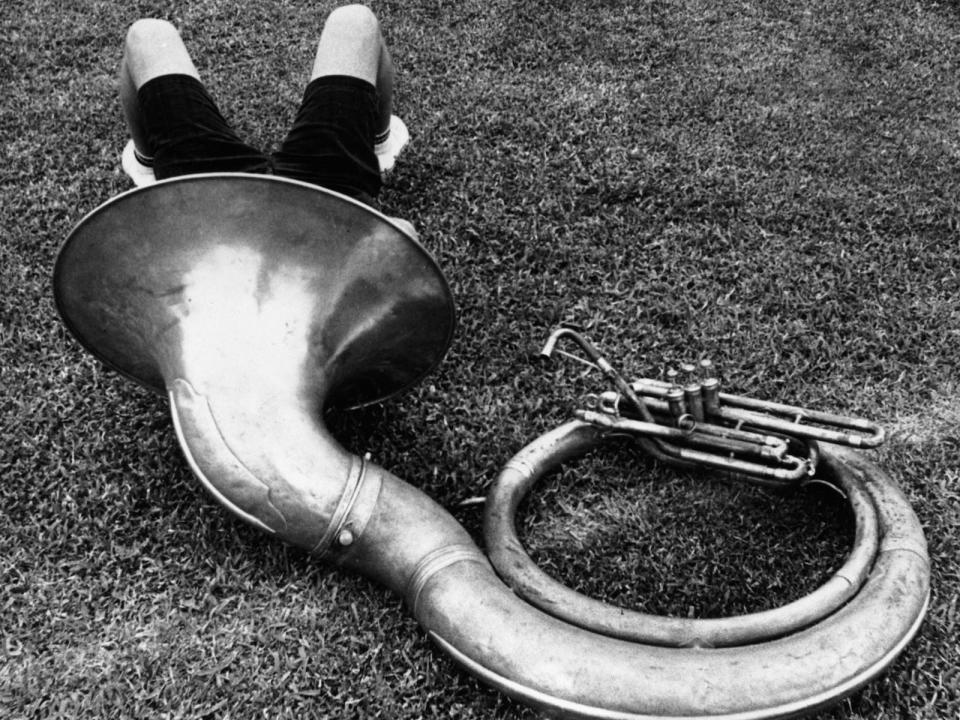 musician with head in instrument