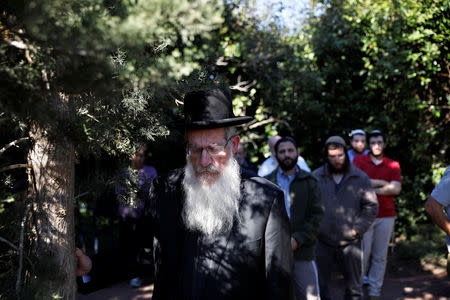 Relatives and friends mourn during the funeral of Israeli rabbi Achiad Ettinger, in the Jewish settlement of Eli in the Israeli-occupied West Bank March 18, 2019. REUTERS/Ronen Zvulun