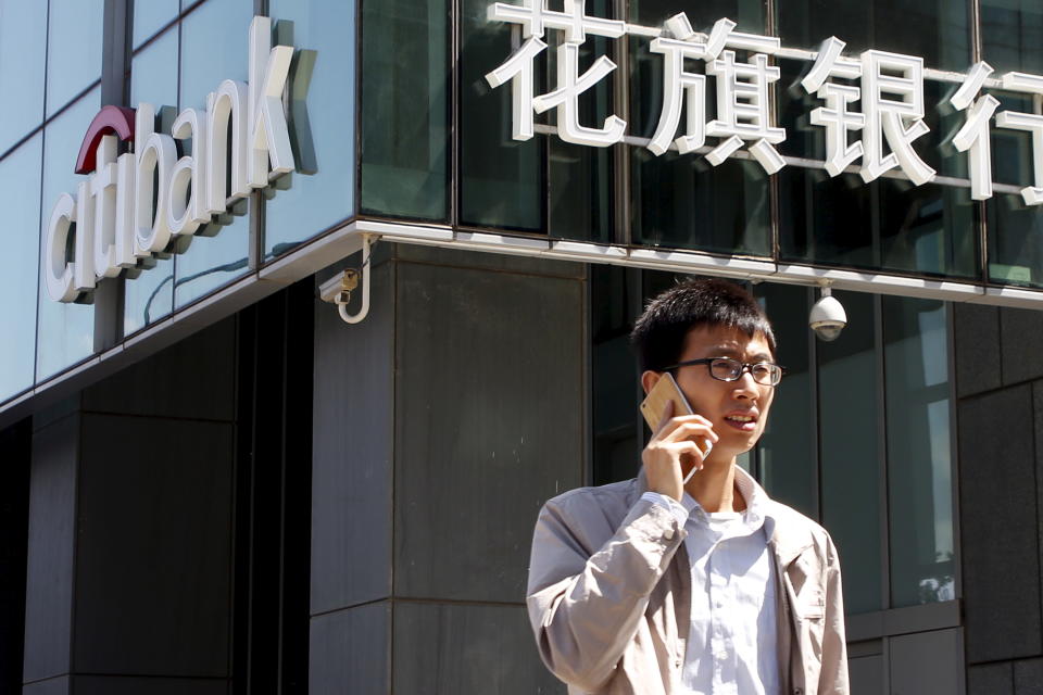 A man talks on his phone outside a branch of Citibank in Beijing, China, April 18, 2016. REUTERS/Kim Kyung-Hoon  