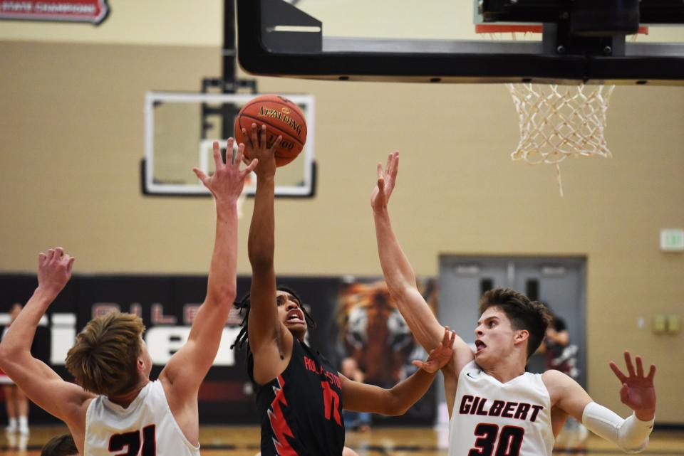 Roland-Story's Isaiah Naylor goes up for a layup between Gilbert's Alex Ruba (left) and Justin Terry during a 57-45 victory by the Norsemen over the Tigers Dec. 2 at Gilbert. Naylor had 14 points in the win.