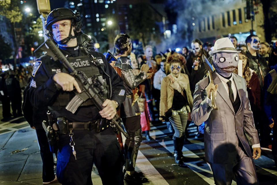 Heavily armed police guard revelers during the Village Halloween Parade on Oct. 31, 2017, in N.Y.C. The city’s always surreal Halloween parade occurred under the shadow of real fear just hours after a truck attack killed several people on a busy bike path in what authorities called an act of terror. (Photo: Andres Kudacki/AP)
