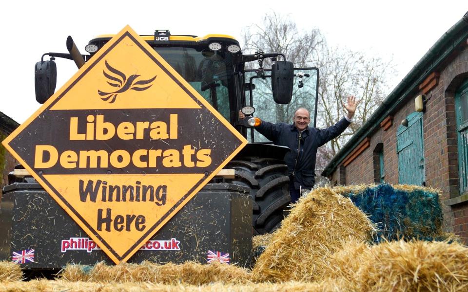 Ed Davey launched the Lib Dem’s campaign in Berkhamsted, where he drove a tractor through a wall of straw bales painted blue - James Street/PA