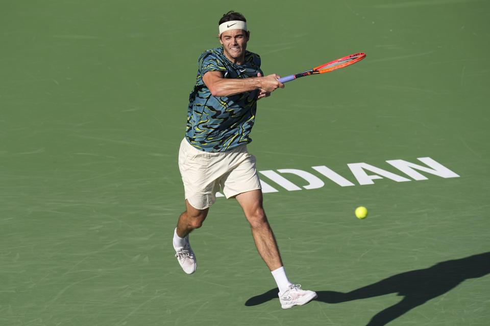 Taylor Fritz returns a shot to Sebastian Baez, of Argentina, at the BNP Paribas Open tennis tournament Monday, March 13, 2023, in Indian Wells, Calif. (AP Photo/Mark J. Terrill)