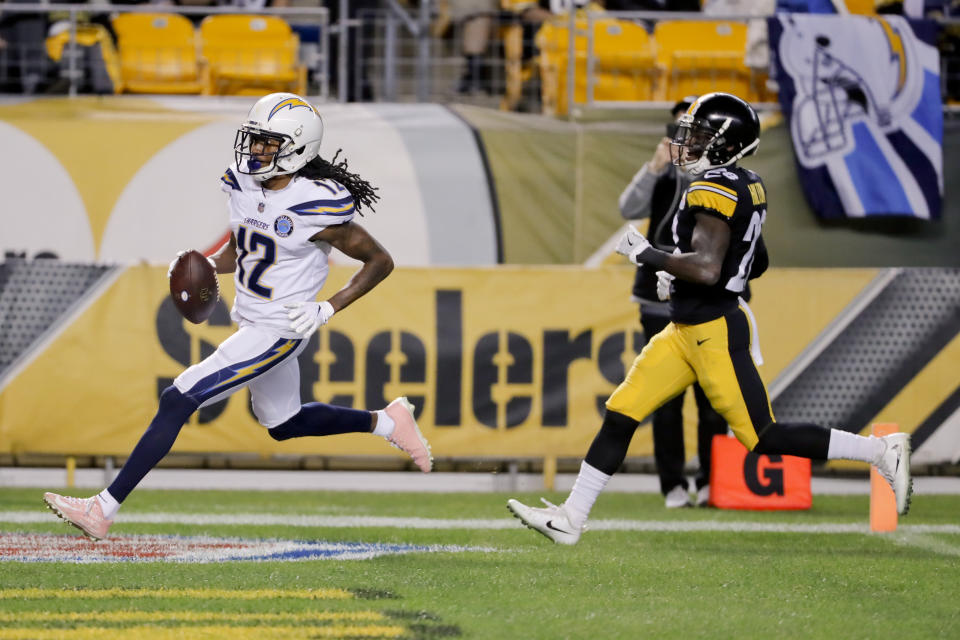 Los Angeles Chargers wide receiver Travis Benjamin (12) dashes past Pittsburgh Steelers cornerback Mike Hilton (28) on his way to a touchdown after making a catch in the first half of an NFL football game, Sunday, Dec. 2, 2018, in Pittsburgh. (AP Photo/Gene J. Puskar)