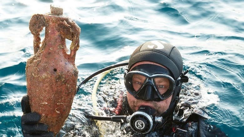 scuba diver holding amphora