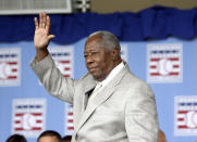 FILE - Hall of Famer Hank Aaron waves to the crowd during Baseball Hall of Fame induction ceremonies in Cooperstown, N.Y., in this Sunday, July 28, 2013, file photo. Hank Aaron, who endured racist threats with stoic dignity during his pursuit of Babe Ruth but went on to break the career home run record in the pre-steroids era, died early Friday, Jan. 22, 2021. He was 86. The Atlanta Braves said Aaron died peacefully in his sleep. No cause of death was given. (AP Photo/Mike Groll, File)