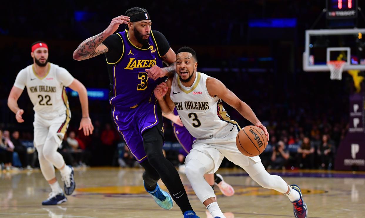 Feb 9, 2024; Los Angeles, California, USA; New Orleans Pelicans guard CJ McCollum (3) moves to the basket against Los Angeles Lakers forward Anthony Davis (3) during the second half at Crypto.com Arena. Mandatory Credit: Gary A. Vasquez-USA TODAY Sports