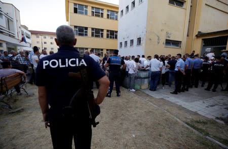 Election workers carry ballot boxes to a local election counting centre in Shkodra