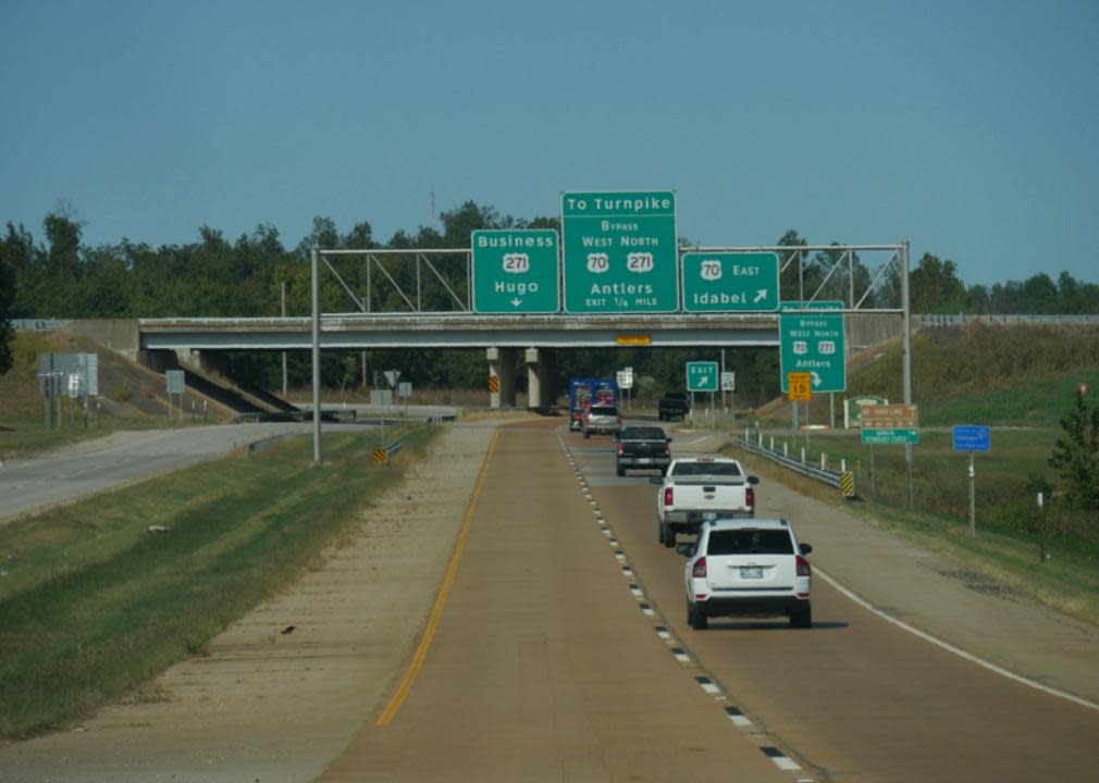 Cars travel under an overpass bridge in Antlers.