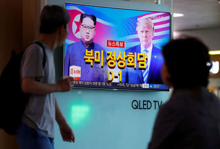 People watch a TV broadcasting a news report on the upcoming summit between the U.S. and North Korea, in Seoul, South Korea, June 11, 2018. REUTERS/Kim Hong-Ji