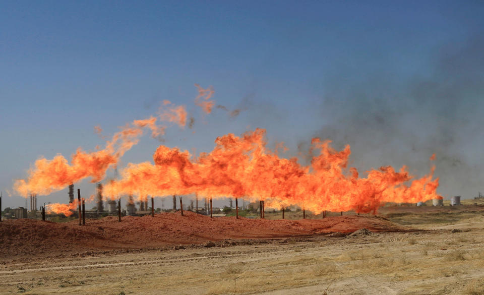 <p>Flames emerge from flare stacks at the oil fields in Kirkuk, Iraq, Oct. 18, 2017. (Photo: Alaa Al-Marjani/Reuters) </p>