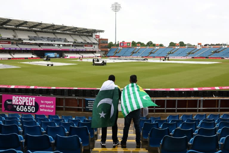 No play today: Fans, draped in Pakistan flags, watch as groundstaff attempt to clear rain water from the pitch ahead of the 1st T20 between England and Pakistan at Headingley. The match was abandoned without a ball being bowled (Darren Staples)