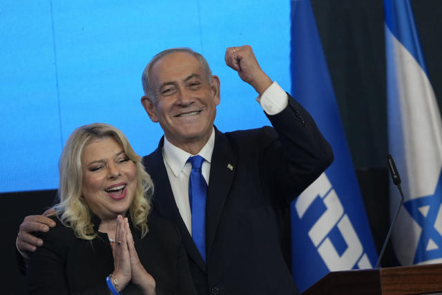 FILE - Former Israeli Prime Minister and the head of Likud party, Benjamin Netanyahu and his wife Sara gesture after first exit poll results for the Israeli Parliamentary election at his party's headquarters in Jerusalem, Wednesday, Nov. 2, 2022. Netanyahu and his allies on Thursday denounced protesters as "anarchists" after they massed outside a Tel Aviv salon where his wife was getting her hair done, a chaotic end to a day of demonstrations against the government's plan to overhaul the judiciary. (AP Photo/Tsafrir Abayov, File)