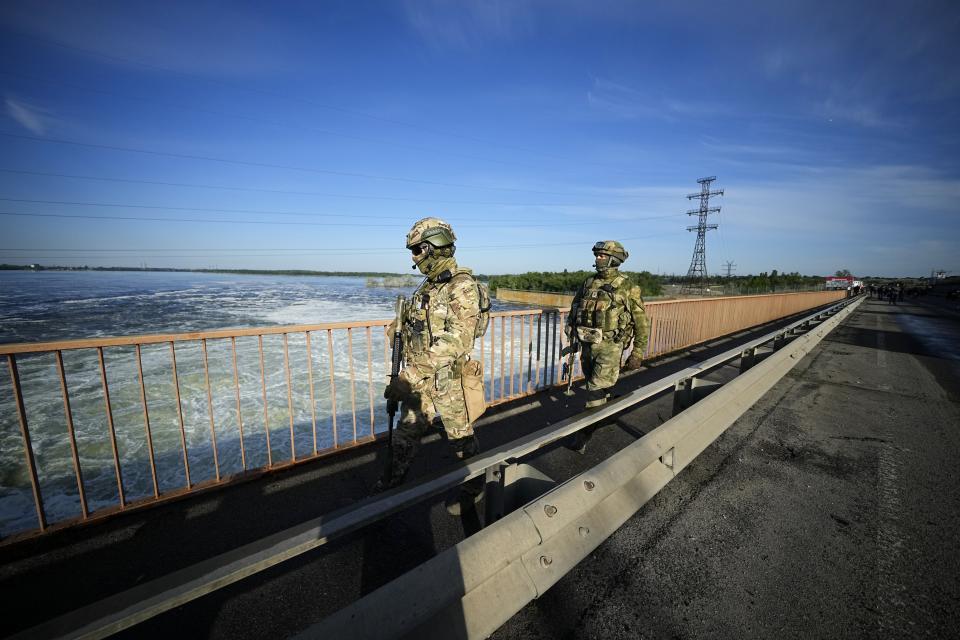 Russian troops patrol an area at the Kakhovka Hydroelectric Station, a run-of-river power plant on the Dnieper River in Kherson region, south Ukraine, Friday, May 20, 2022. The Kherson region has been under control of the Russian forces since the early days of the Russian military action in Ukraine. This photo was taken during a trip organized by the Russian Ministry of Defense. (AP Photo)