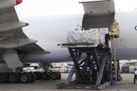 In this photo released by the Taiwan Centers for Disease Control, workers unload COVID-19 vaccines from a China Airlines cargo plane from Memphis that arrived at the airport outside Taipei in Taiwan, Sunday, June 20, 2021. The U.S. sent 2.5 million doses of the Moderna COVID-19 vaccine to Taiwan on Sunday, tripling an earlier pledge in a donation with both public health and geopolitical meaning. (Taiwan Centers for Disease Control via AP)