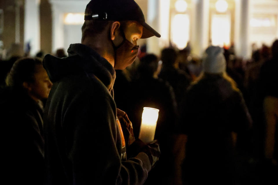Luke Sommers, of Centerville,Va., takes a moment to himself as he gathers for a candlelight vigil after a shooting that left three students dead the night before at the University of Virginia, Monday, Nov. 14, 2022, in Charlottesville, Va. (Shaban Athuman/Richmond Times-Dispatch via AP)