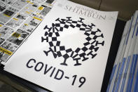 FILE - In this May 19, 2020, file photo, the cover design of Number 1 Shimbun is seen in Tokyo, Tuesday, May 19, 2020. The Foreign Correspondents’ Club of Japan removed a parody drawing that uses the Tokyo Olympic logo combined with features of the COVID-19 virus from their website after receiving a demand for withdrawal from the organizing committee. (AP Photo/Eugene Hoshiko, File)