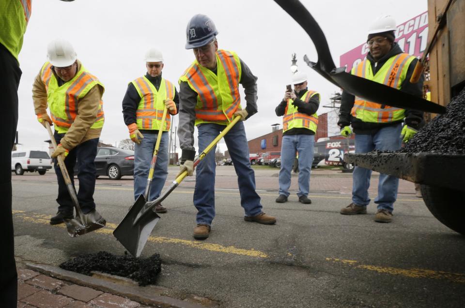 Republican Rick Snyder, Whitmer's predecessor as governor, joined a pothole repair crew one day in 2015 to help promote a sales tax initiative that would have helped finance road maintenance. The initiative failed badly at the polls. (Photo: ASSOCIATED PRESS)