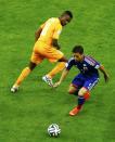 Ivory Coast's Salomon Kalou (L) fights for the ball with Japan's Yuto Nagatomo during their 2014 World Cup Group C soccer match at the Pernambuco arena in Recife June 14, 2014. REUTERS/Ruben Sprich