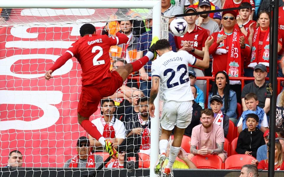 Liverpool's Joe Gomez in action with Tottenham Hotspur's Brennan Johnson