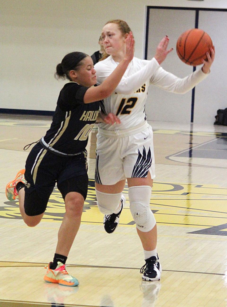 - Mooresville senior Ally Graber passes to a teammate around the defense of Decatur Central junior Marier Fuller during Friday's Mid-State Conference game against Decatur Central. 