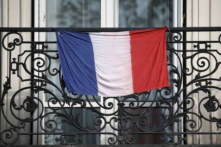 A French flag hangs from a balcony in Paris, France November 26, 2015. REUTERS/Charles Platiau