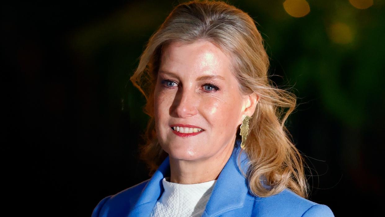  Duchess Sophie wearing gold earrings and a blue blazer. 