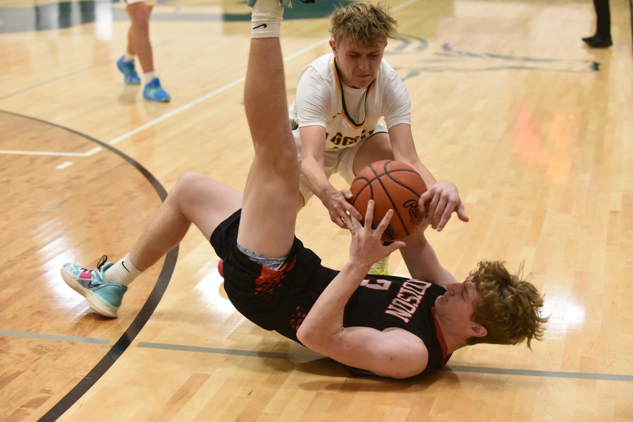 Sand Creek's Braylon Gartee and Addison's Spencer Brown fight for the ball during Tuesday's game at Sand Creek.