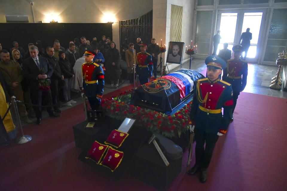 People pay their last respects to slain Russian military blogger Vladlen Tatarsky, during a funeral ceremony at the Troyekurovskoye cemetery in Moscow, Russia, Saturday, April 8, 2023. Tatarsky, known by his pen name of Maxim Fomin, was killed on Sunday, April 2, as he led a discussion at a riverside cafe in the historic heart of St. Petersburg, Russia's second-largest city. (Anton Velikzhanin, Moscow News Agency photo via AP)