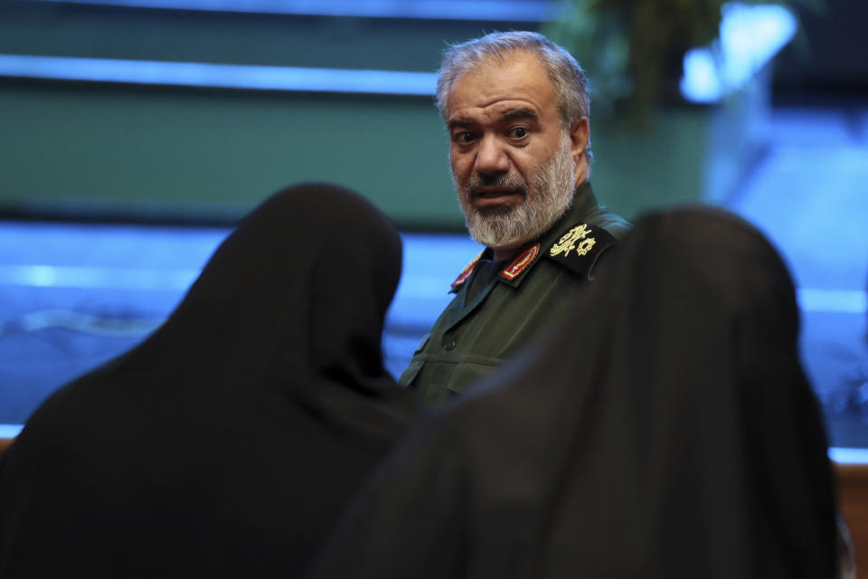 Deputy commander of the Iran's Revolutionary Guard Gen. Ali Fadavi speaks with two female members of the Guard-affiliated Basij paramilitary force in one of the ceremonies marking "Basij Week" and also commemorating the 40th anniversary of establishment of the force, in Tehran, Iran, Sunday, Nov. 24, 2019. (AP Photo/Vahid Salemi)