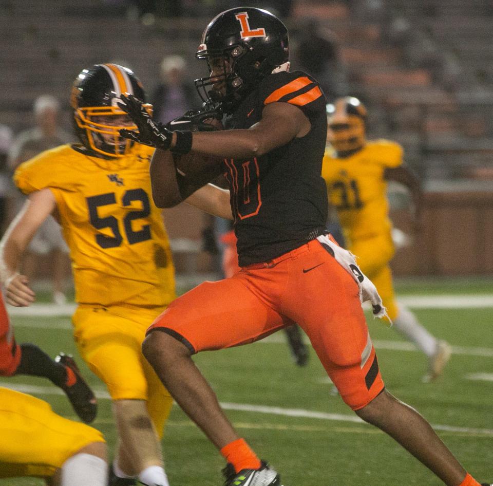 Lakeland High School's Tyler Williams (10) returns a 75 yard punt return for a touchdown against Winter Haven High School during the second quarter at Bryant Stadium in Lakeland Friday night. September 9, 2022.