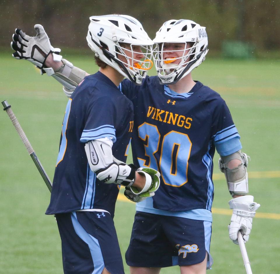 Cape Henlopen's Luke Burton (left) and Burke Healy celebrate a goal by Burton in the second half of the Vikings' 13-8 win at Archmere Academy, Saturday, April 1, 2023.