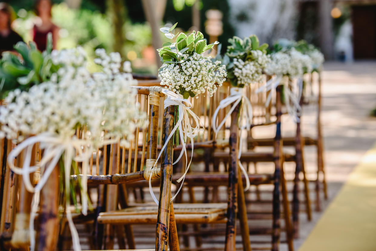 Floral arrangements for empty chairs for a wedding ceremony in spring