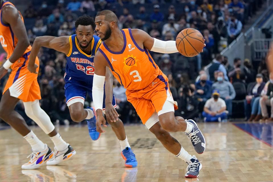 Phoenix Suns guard Chris Paul (3) drives against Golden State Warriors forward Andrew Wiggins during the first half of an NBA basketball game in San Francisco, Friday, Dec. 3, 2021. (AP Photo/Jeff Chiu)