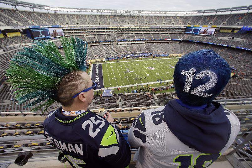 Seattle Seahawks fans John Hanshaw, left, and Pete Ford, both of Tacoma, Wash., watch the field before the NFL Super Bowl XLVIII football game between the Seattle Seahawks and the Denver Broncos, Sunday, Feb. 2, 2014, in East Rutherford, N.J. (AP Photo/Mel Evans)