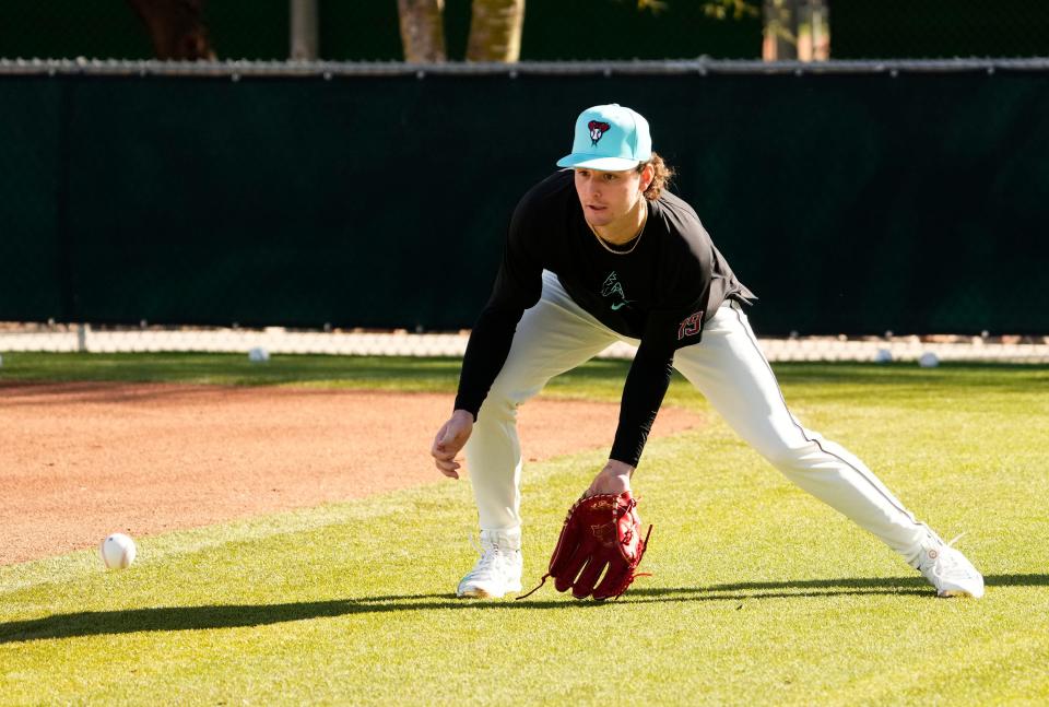 Arizona Diamondbacks pitcher Ryne Nelson (19) fields a ground ball during spring training workouts at Salt River Fields at Talking Stick near Scottsdale on Feb. 15, 2024.