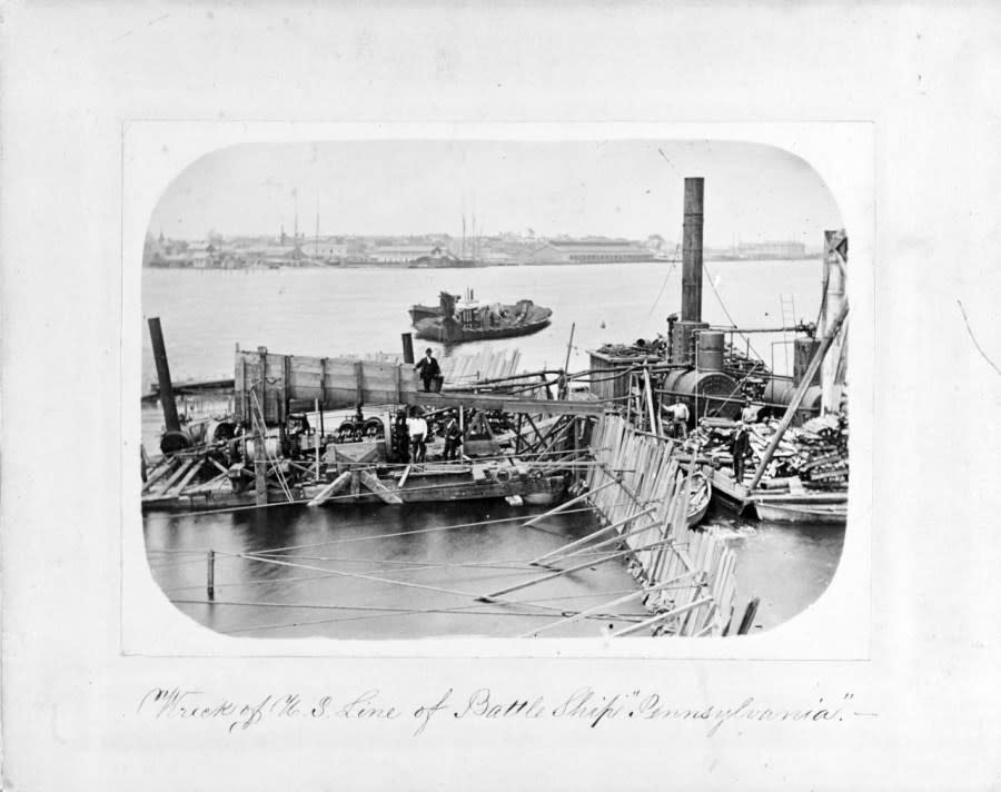 Photograph taken circa the later 1860s, entitled Wreck of the U.S. Line of Battle Ship ‘Pennsylvania’. It depicts salvage operations on the burned and sunken ship, off the Norfolk Navy Yard, Portsmouth, Virginia. Note the burned ship hull floating in the middle distance, steam salvage engines and boilers, with their associated barge at right. (U.S. Naval History and Heritage Command Photograph.)