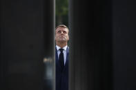 FILE - In this May 8, 2020 file photo, French President Emmanuel Macron looks up at the statue of General Charles de Gaulle during VE Day ceremonies. With a year to go to the presidential vote, French President Emmanuel Macron is getting ready for a potential re-election bid by prioritizing reviving the economy and saving jobs. The country is slowly stepping out of its partial lockdown. Macron’s ability to meet the challenge will be key _ as France is among countries worst hit by the pandemic in the world, with over 105,000 virus-related deaths. (AP Photo/Francois Mori, Pool, File)