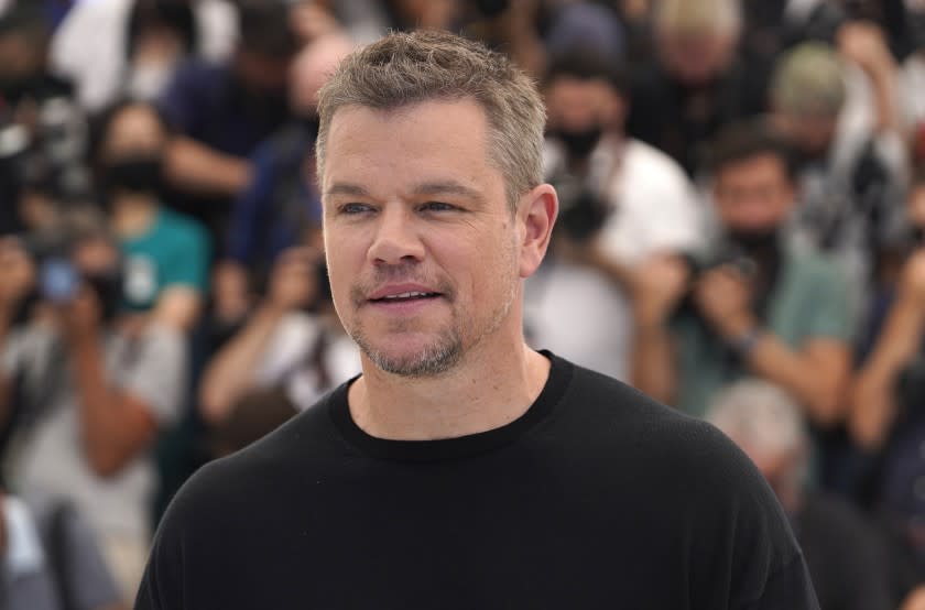 A man posing in a black T-shirt