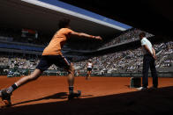 A ball boy give a ball as Jessica Pegula of the U.S.walks back while playing Poland's Iga Swiatek during their quarterfinal match of the French Open tennis tournament at the Roland Garros stadium Wednesday, June 1, 2022 in Paris. (AP Photo/Jean-Francois Badias)