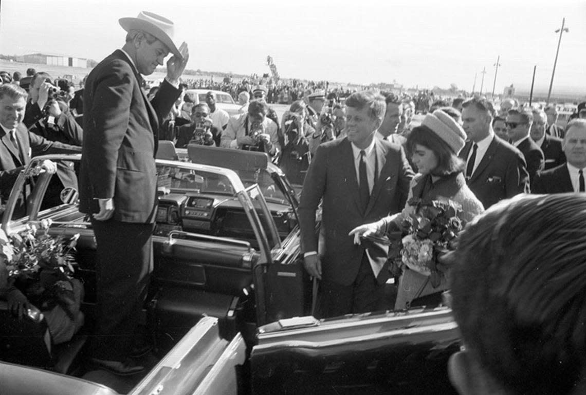 Nov. 22, 1963: Texas Gov. John Connally tips his hat to President John F. Kennedy and wife Jackie as they enter the convertible limousine at Love Field in Dallas.